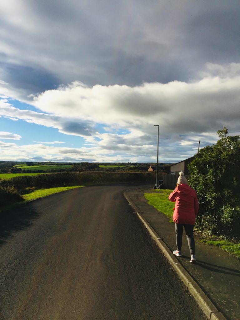 picture of debs striding out into the countryside around durham