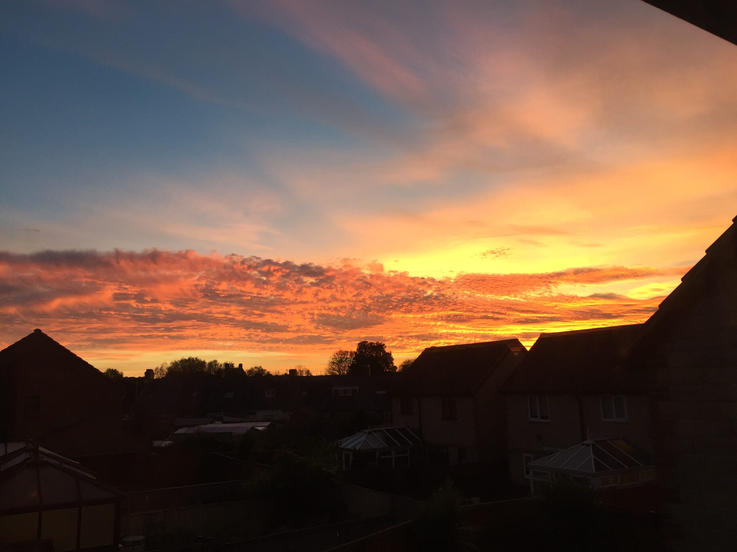 Sunset in Durham Gilesgate in October 2018 with house line silhouetted against a fiery red sky